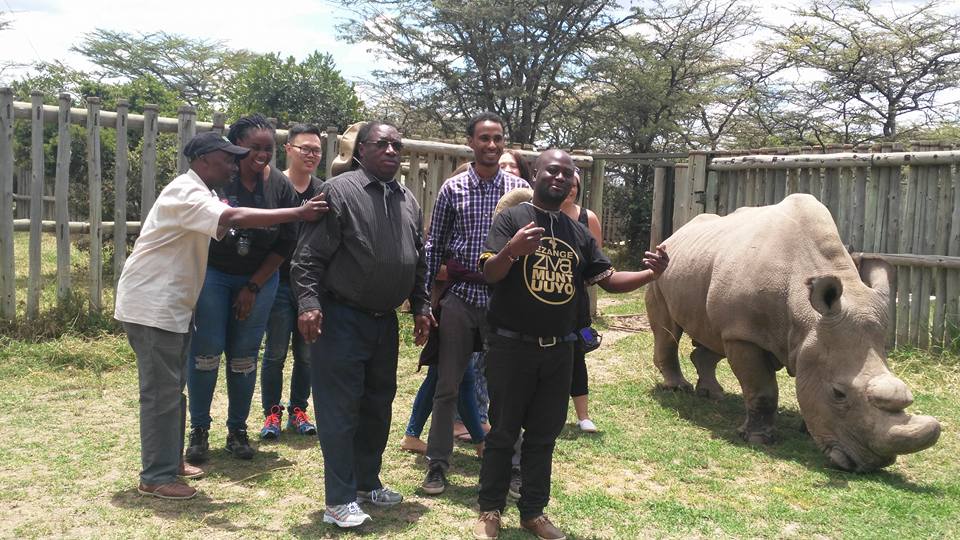 A photograph taken with fellow travel journalists with a rhino called Sudan in Nanyuki, 'Magical Kenya'